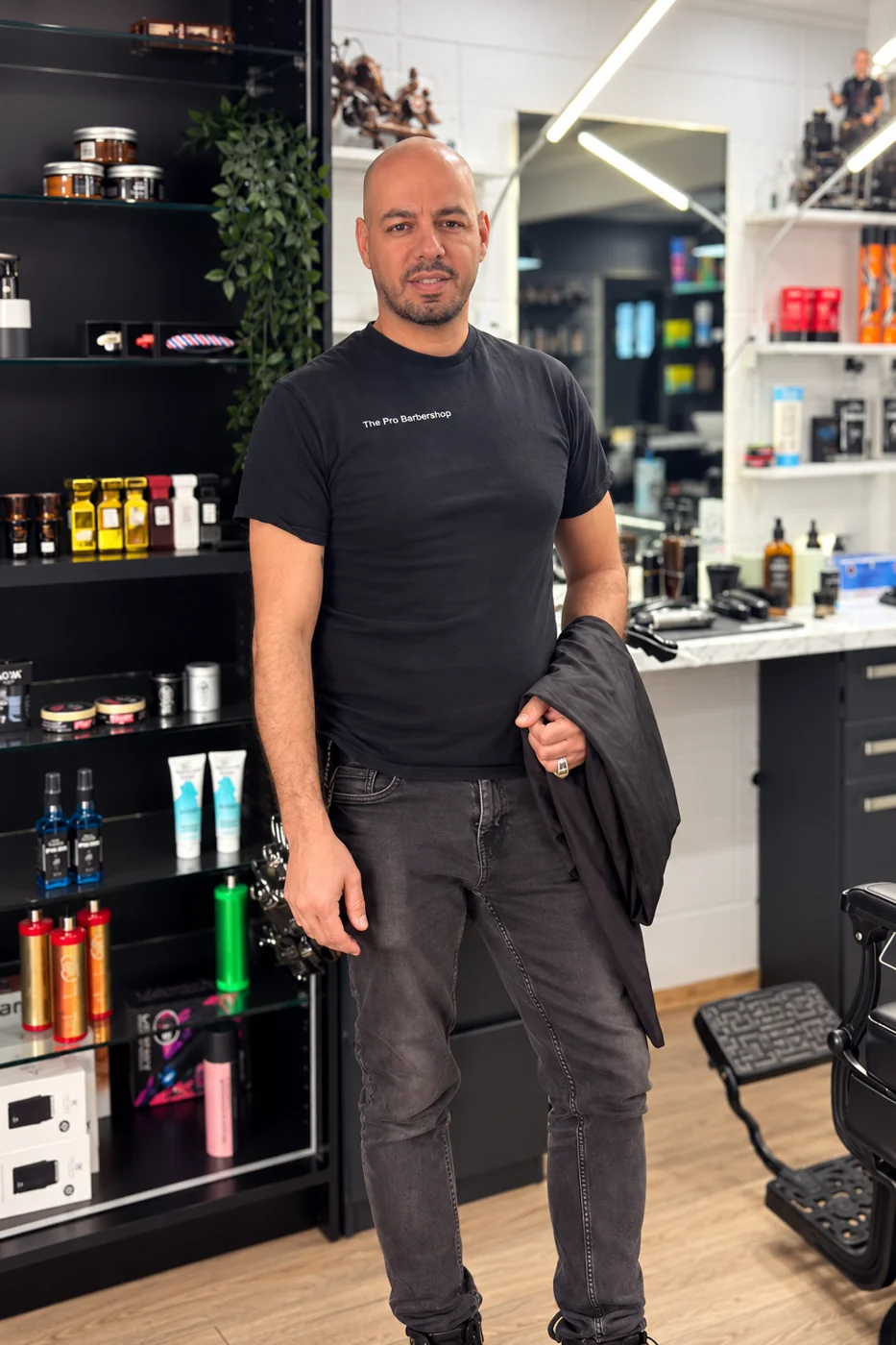 Barber standing inside The Pro Barbershop