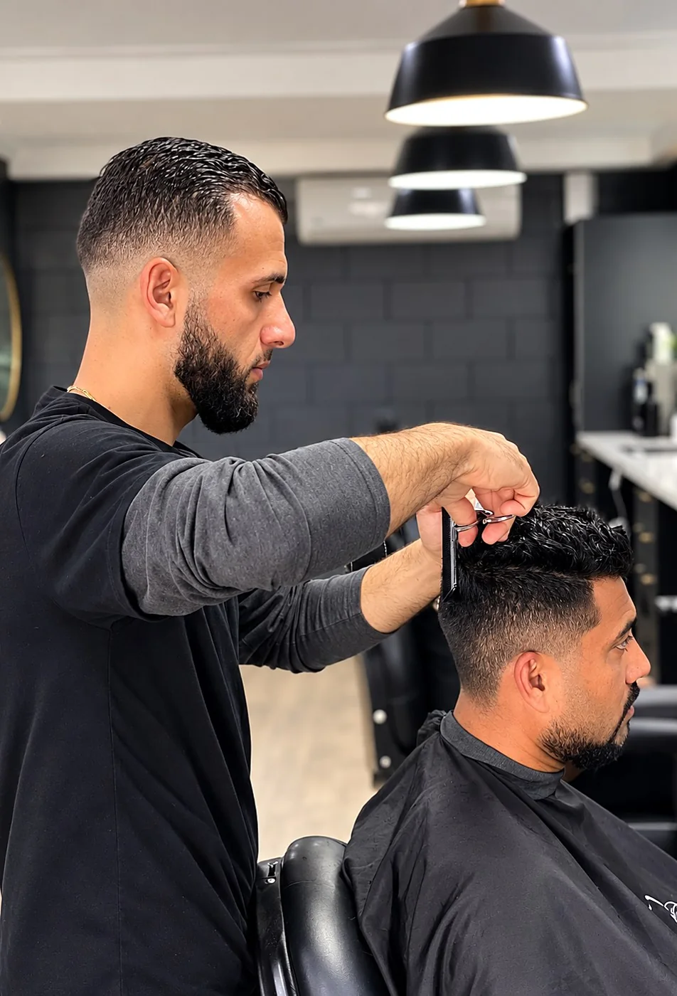 Barber cutting hair with scissors